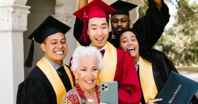 an elderly woman taking a groupie with the graduates