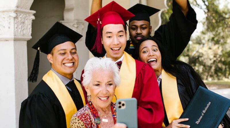 an elderly woman taking a groupie with the graduates
